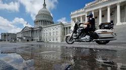A U.S. Capitol Police officer rides a motorcycle past the U.S. Capitol on Sept. 11.