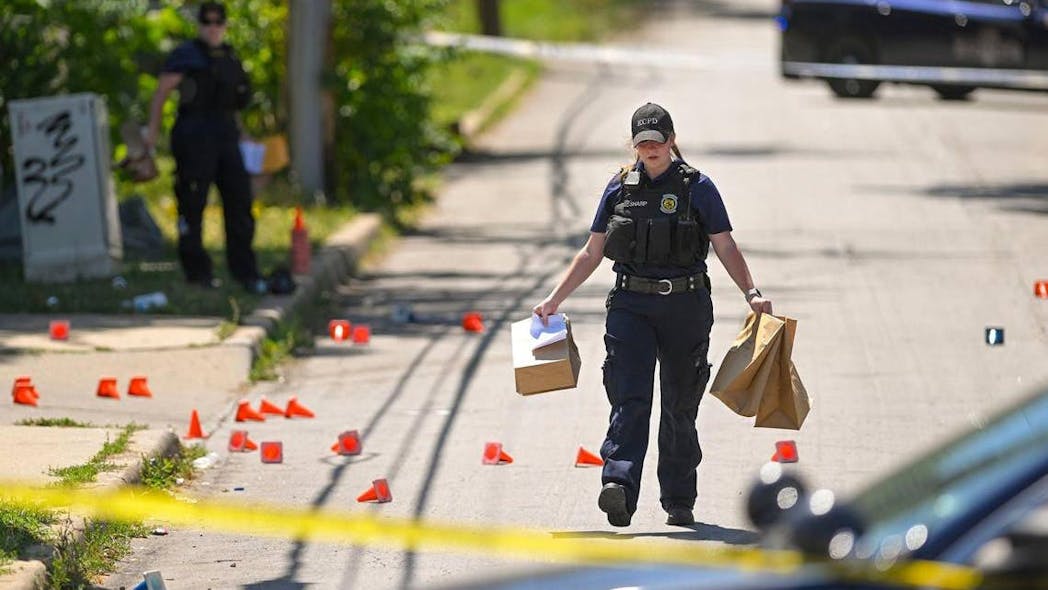 Police and crime scene investigators collecting evidence after a shooting in killed three people and injured six others in late June outside an auto shop known for hosting gatherings near 57th Street and Prospect Avenue in Kansas City. This year could become Kansas City s deadliest year.
