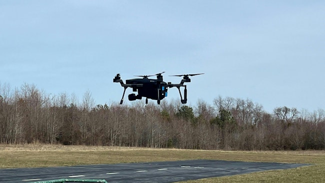 The SIRAS drone is seen hovering about 12' off the ground prior to flight testing.