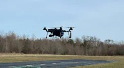 The SIRAS drone is seen hovering about 12' off the ground prior to flight testing.