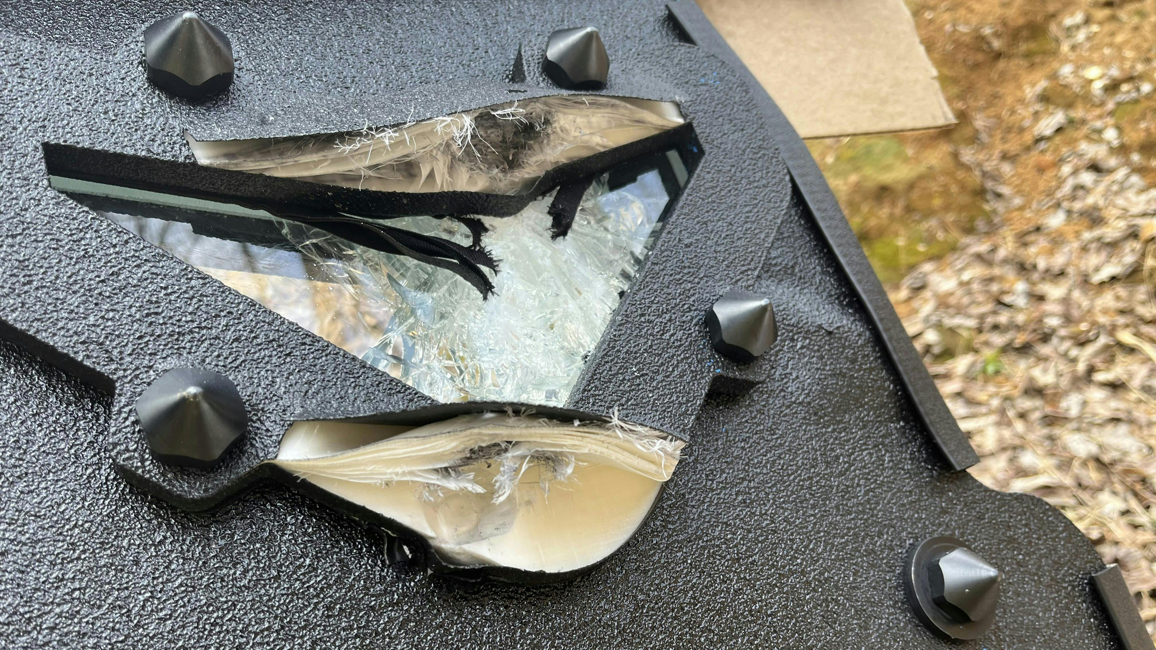 The viewport is seen after three .223 rounds were fired on it. Two hit the frame; one hit directly on glass. There was no penetration.