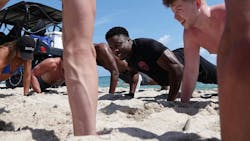 Fort Lauderdale, FL, Police Department Detective Henry Lockwood challenges spring breakers from State University of New York Oswego to push-ups on the beach on Wednesday. The agency is actively hiring and has decided to try a new strategy: reach out to spring breakers.