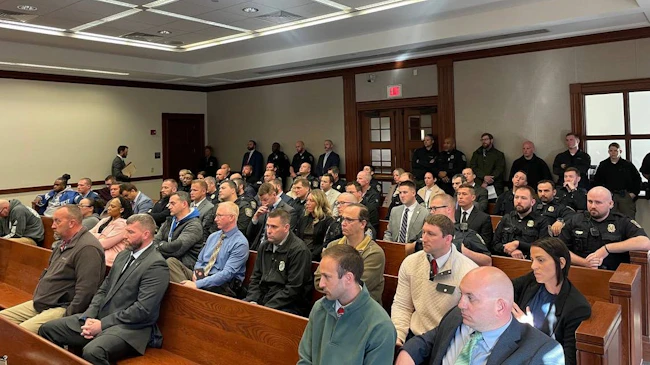 Officers and detectives with the Lexington Police Department fill the courtroom gallery Monday during a preliminary hearing against three men charged with shooting an officer.