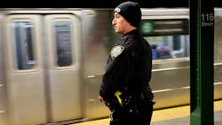 An NYPD officer patrols the 116th Street and Lexington Avenue subway station.