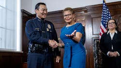 New LAPD interim Chief Dominic H. Choi shakes hands with Mayor Karen Bass after being named to the position in February.