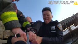An NYPD officer is helped by fellow officers and FDNY fighters to rescue a woman who jumped into the frigid waters of the Hudson River on Thursday.