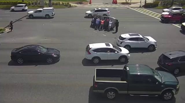 Video shows good Samaritans flipping car that overturned in crash