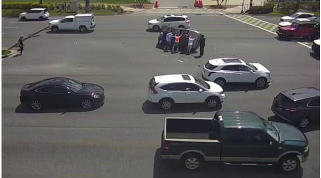 Video shows good Samaritans flipping car that overturned in crash