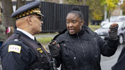 Chicago police Cmdr. William Betancourt of the 10th District speaks with Ald. Monique Scott, 24th, on Oct. 29, 2023, talk at the scene of a shooting that wounded 15 people at 1258 S. Pulaski Rd. in North Lawndale.