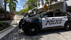 Doral, FL, police cruisers are stationed before the roundabout inside CityPlace Doral on Saturday. A security guard and a gunman were killed, and seven others were injured, including a Doral police officer, in a shootout.