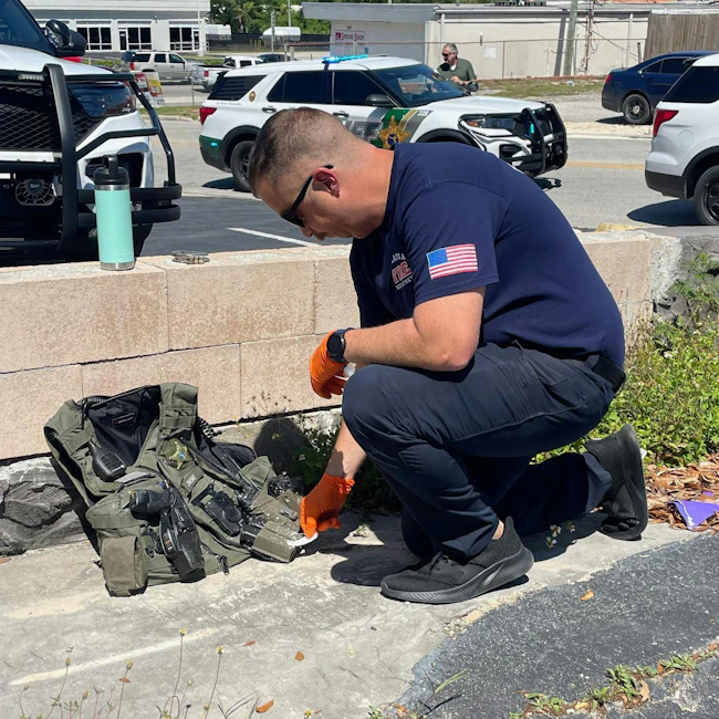 Investigators check out the scene of a Palatka, FL, traffic stop Friday in which a Putnam County sheriff's deputy was covered in a white powder when a mysterious device exploded.
