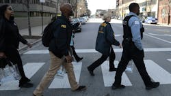 Chicago police, U.S. Secret Service, FBI and other agencies canvass the area near McCormick Place on Monday to provide information to businesses and residents about heightened security during this summer&rsquo;s Democratic National Convention in the city.