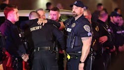 Police officers from several agencies gather at Upstate University Hospital&apos;s emergency room in Syracuse, NY, after an officer and an Onondaga County sheriff&rsquo;s deputy were fatally shot in Salina on Sunday