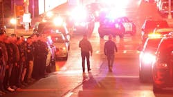 Two officers walk down East Adams Street and follow the escort of two slain officers to the Wally Howard Forensics Science Center in Syracuse, NY. Dozens of officers from several agencies gathered at Upstate University Hospital&apos;s emergency room in Syracuse after two officers were fatally shot in Salina on Sunday.