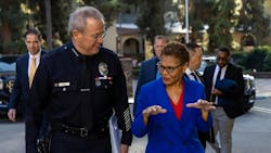 Then LAPD Chief Michel Moore walks alongside Mayor Karen Bass at the Police Academy in December.