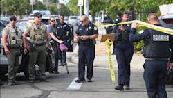 Fresno Police Chief Paco Balderrama, center, collects information on a homicide that occurred in the roadway on Union Avenue at Cedar near McLane High School on Monday, Sept. 18, 2023.