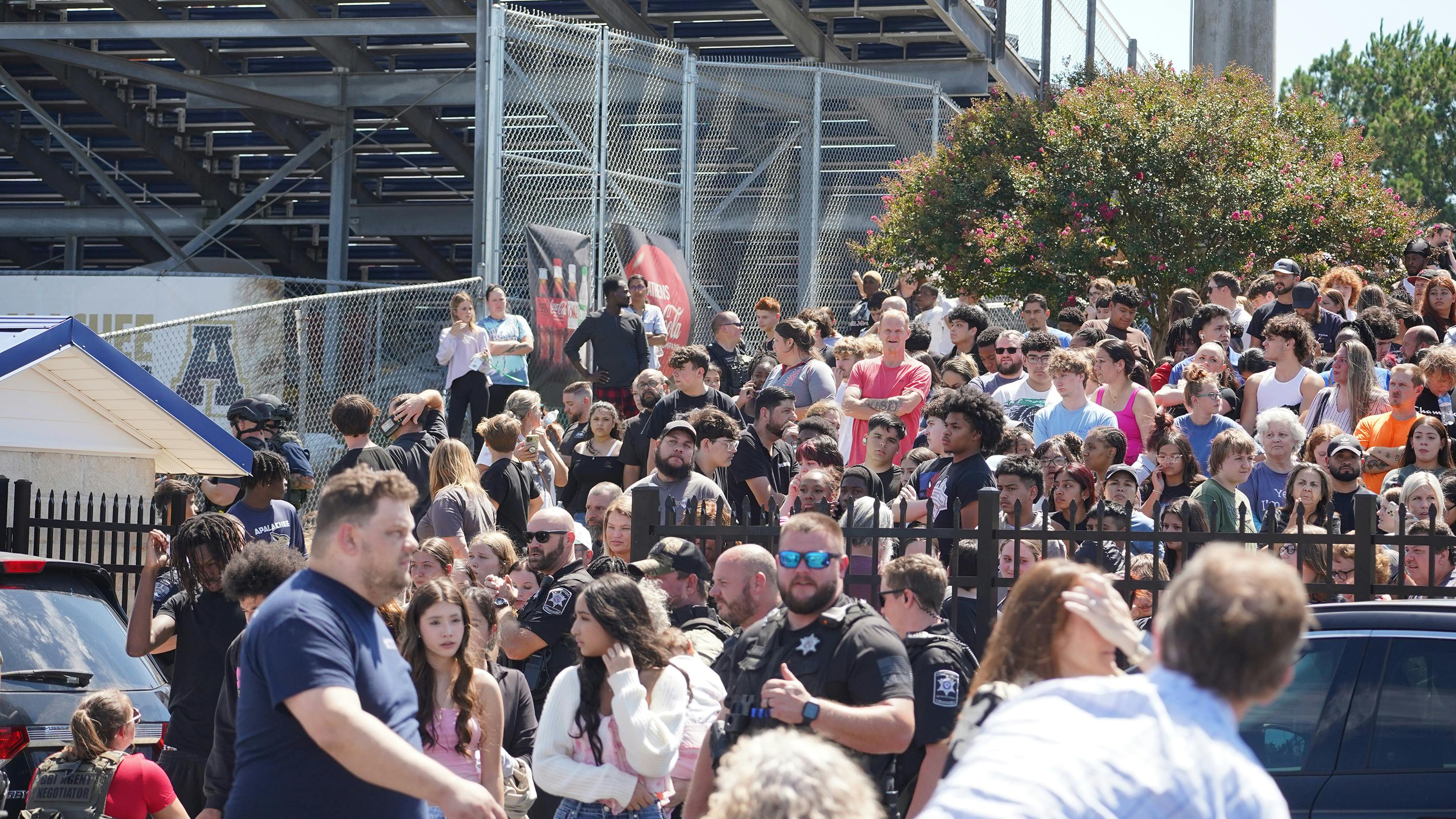 Students wait to be picked up by their parents after a shooting at Apalachee High School on Sept. 4, 2024, in Winder, Georgia. Multiple fatalities and injuries have been reported and a suspect is in custody according to authorities.