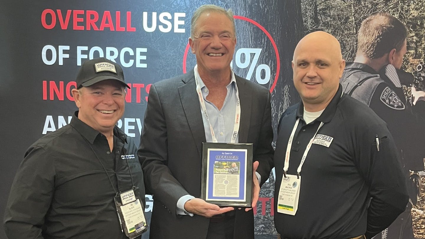OFFICER Magazine's Tom Burr (left0 and Bill MacRae (right) with Pepperball CEO Bill Plaschke.