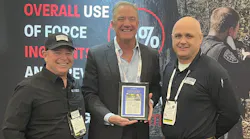 OFFICER Magazine's Tom Burr (left0 and Bill MacRae (right) with Pepperball CEO Bill Plaschke.
