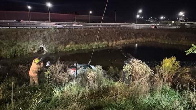 Two Virginia State Police rescued a woman trapped inside a vehicle submerged in a Fairfax County retention pond Sunday.