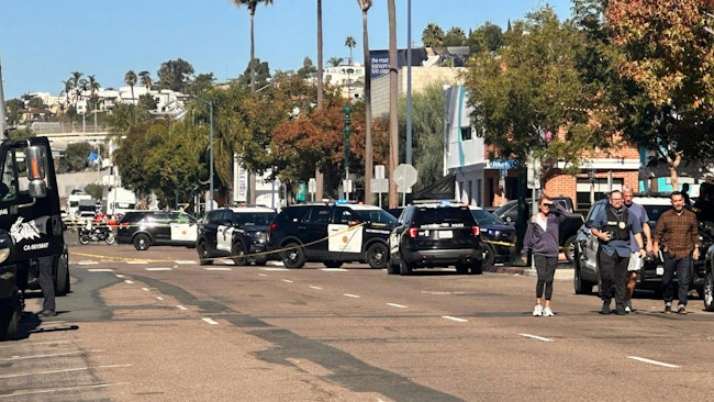 Authorities investigate a shootout in San Diego involving a Harbor Police officer and a suspect, who both were struck by gunfire Wednesday.