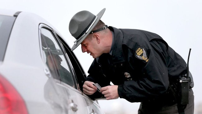 Ohio State Highway Patrol trooper conducts a traffic stop. A bipartisan bill looks to ban ticket quotas for state law enforcement.