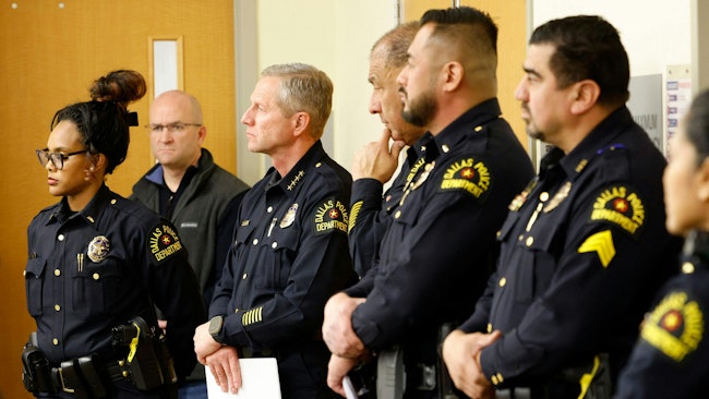 Interim Dallas Police Chief Michael Igo (third from left) stands with other police officers during a community meeting in Pleasant Grove in Dallas on Feb. 20