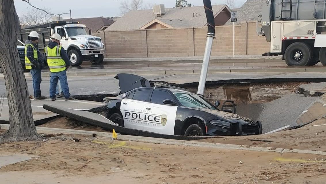 A Rio Rancho, NM, police officer was inside his cruiser when it fell into a sinkhole caused by a water main break Sunday.