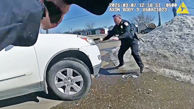 A Bismarck Police Officer Suffered An Injured Knee When He Was Struck By An Suv And Launched Several Feet Over A Snow Bank Into A Fence By A Fleeing Driver, Who Was Fatally Shot By Another Officer