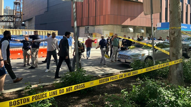 Boston police investigate a shooting outside Massachusetts General Hospital on Tuesday.