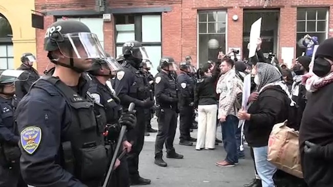 Protesters Numbering In The Hundreds Shattered Windows And Vandalized San Francisco Buildings During A Demonstration Against Federal Immigration Raids, Injuring Three Police Officers And Damaging A Cruiser