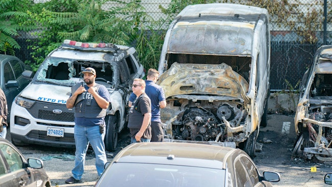 Multiple NYPD vehicles were torched by an arsonist while they were parked in a lot in Brooklyn early Thursday.