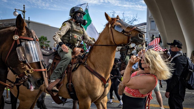 Protesters clash with law enforcement at the 'No Kings' Day demonstration in downtown Los Angeles on Saturday.