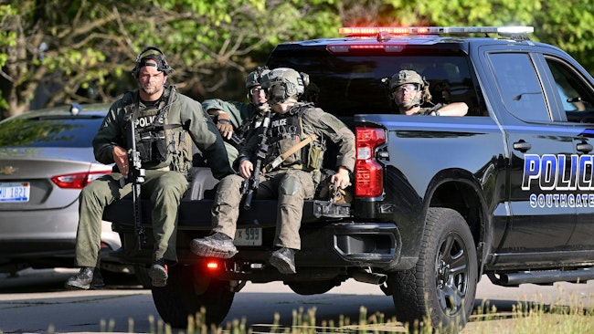 Police officers from multiple departments conduct a manhunt near a Southgate, MI, apartment complex Thursday.