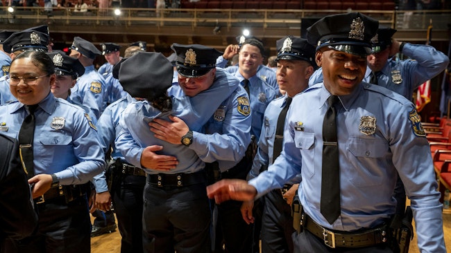 Philadelphia police academy graduates congratulate each other following ceremonies in June 2024.