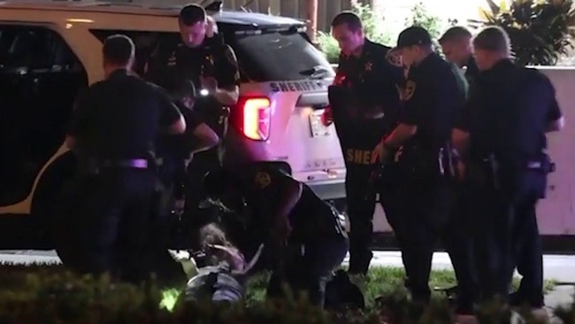 A Handcuffed Woman Being Driven To Jail In The Back Of A Cruiser Fired A Barrage Of Shots, Grazing A Marion County Sheriff's Deputy Near His Right Eye And Sending The Vehicle Into A Utility Pole