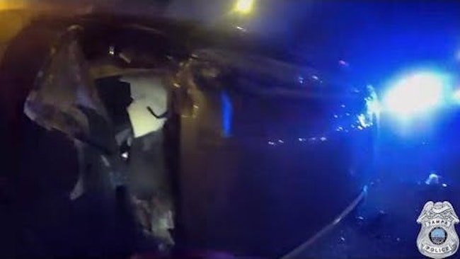 When Tampa Police Responded To A Vehicle That Had Flipped On Its Side And Caught Fire, Officers Quickly Shattered The Windshield And Pulled The Trapped Driver To Safety
