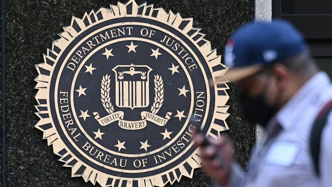 A pedestrian walks past the J. Edgar Hoover FBI building, in Washington, D.C.