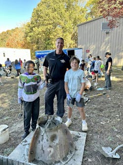 A Calvert County SRO assists students with the creation of an oyster reef project. A Calvert County SRO assists students with the creation of an oyster reef project.
