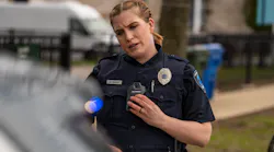 An officer is seen wearing a Motorola Solutions SVX Remote Speaker Microphone enabled with Assist.
