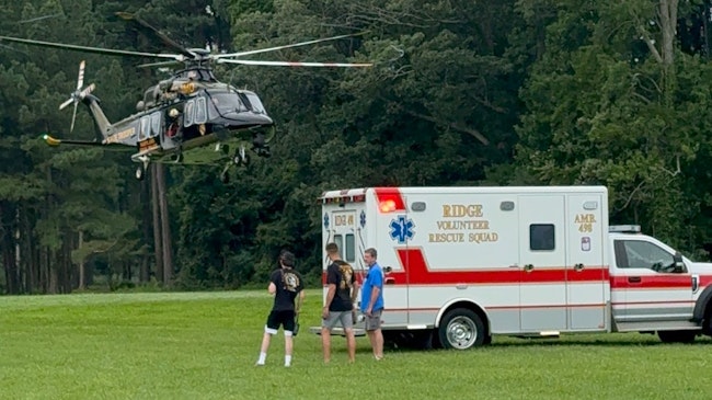 Three people were rescued from an overturned boat in the Chesapeake Bay on Saturday.