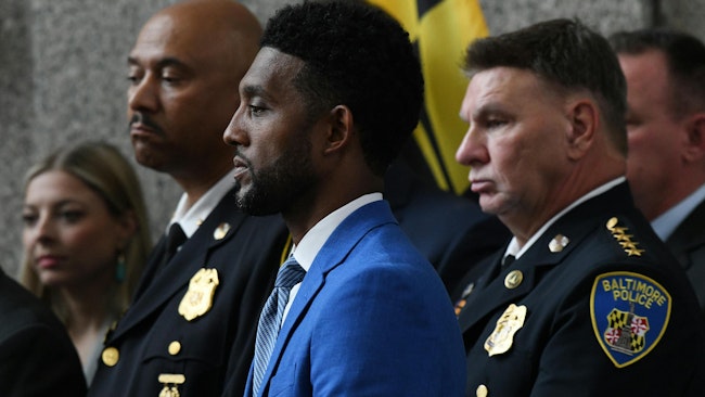 From left, Baltimore County Police Chief Robert O. McCullough, Baltimore City Mayor Brandon Scott and Baltimore City Police Commissioner Richard Worley at a press conference at Baltimore City Police Headquarters announcing indictments in two robbery sprees.