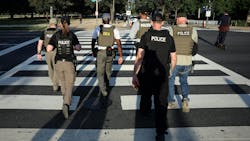 Federal law enforcement officers patrol on the National Mall in Washington, D.C., on Tuesday. Federal law enforcement officers patrol on the National Mall in Washington, D.C., on Tuesday.