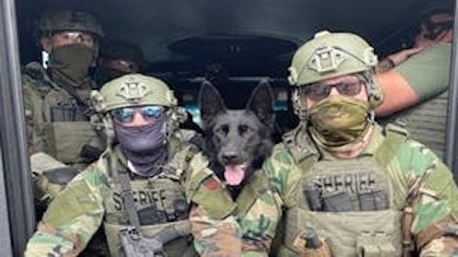 Iredell County, NC, sheriff's deputies wear face coverings while executing search warrants for illegal drugs Aug. 8.