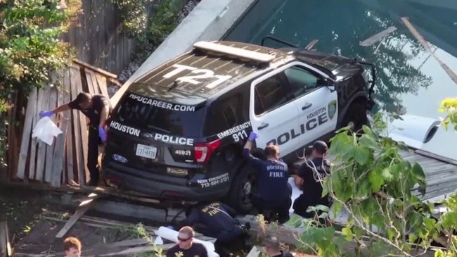 A Houston Police Officer Was Trying To Pull Over An Erratic Driver When His Cruiser Was Struck By An Suv And Sent Through A Fence Before It Was Left Dangling Over The Sun Ledge Of A Backyard Pool