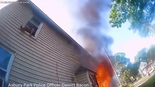 Asbury Park, NJ, police officers caught an 8-year-old boy who jumped from a second-floor window to escape a burning house Monday.