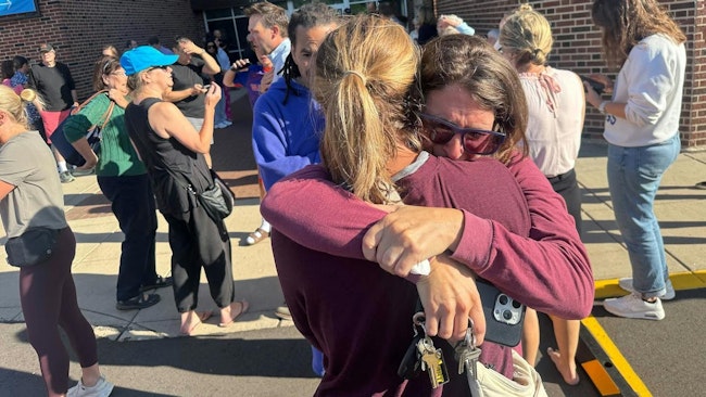 Parents await news of their children after a shooting near Annunciation Church in Minneapolis on Wednesday.