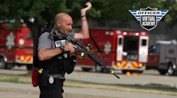 An Indianola, IA, police officer carries a rifle during an active shooter training session.
