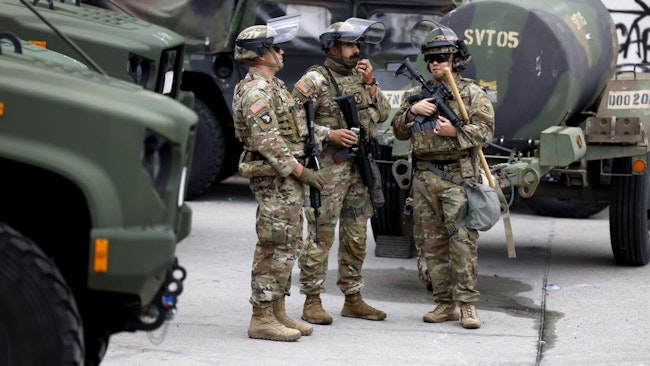 National Guard troops stationed at the Metropolitan Detention Center in Los Angeles in June. A federal judge's ruling Tuesday strictly limits what the remaining soldiers deployed in the state can do.