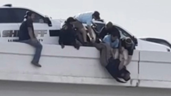 Two Lubbock County sheriff's deputies helping a stranded motorist were seriously injured when a tractor-trailer struck a parked their cruiser, pinning them against a guardrail as bystanders helped until first responders could arrive,